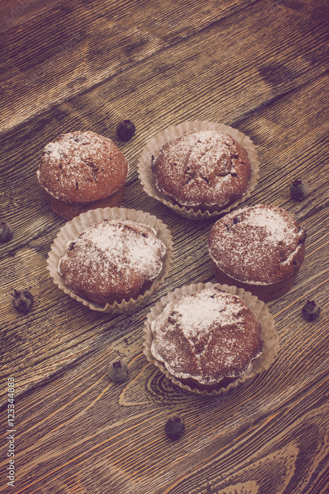 cupcake with berries on wooden background cupcake with berries on wooden background