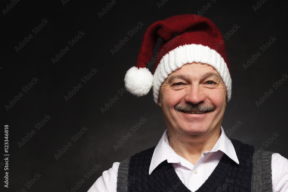 Happy man in a New Year's cap laughing. Preparing for the New Year and Christmas Happy man in a New Year's cap laughing. Preparing for the New Year and Christmas