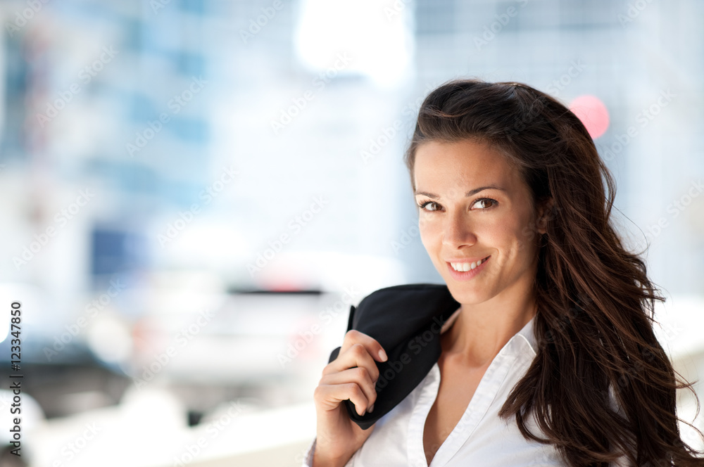 Young Business Woman Outdoors with Coat over Shoulder