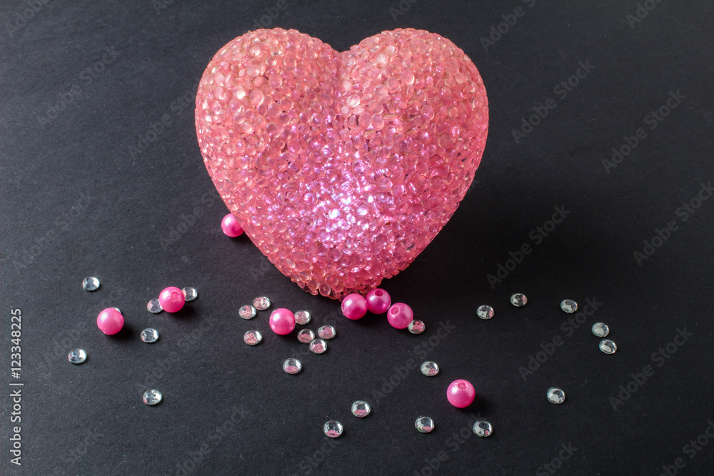 shining heart with rhinestones and beads on a black background shining heart with rhinestones and beads on a black background