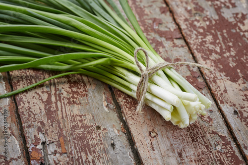 spring onions on dark wood