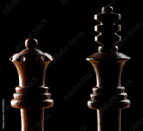 Black King and Queen chess pieces on black