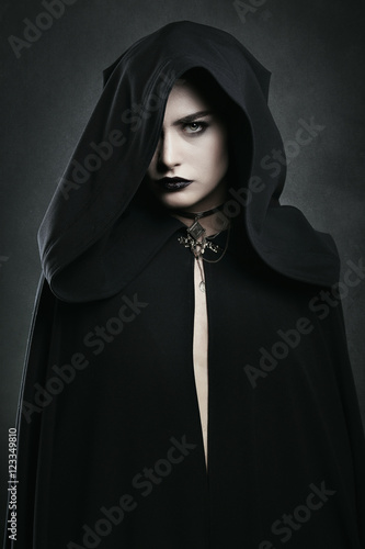 Beautiful vampire woman with black cloak