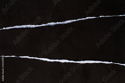 Ripped crumpled black paper with space