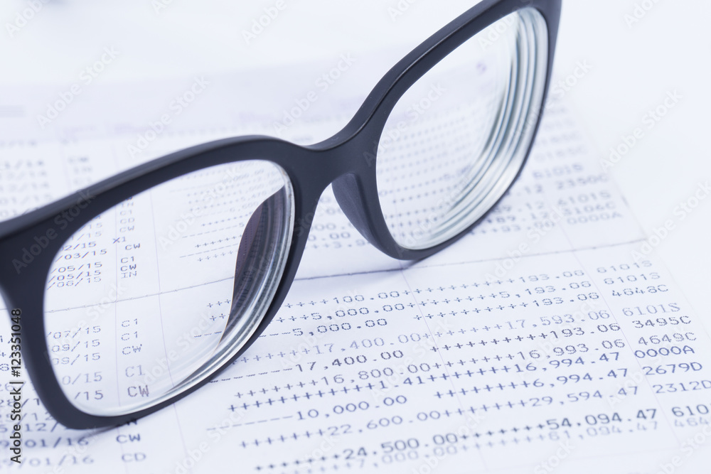 Finance Concepts, glasses with passbook as background Finance Concepts, glasses with passbook as background