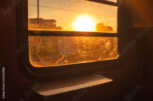 Sunset seen from old train window. Traveller sunset 