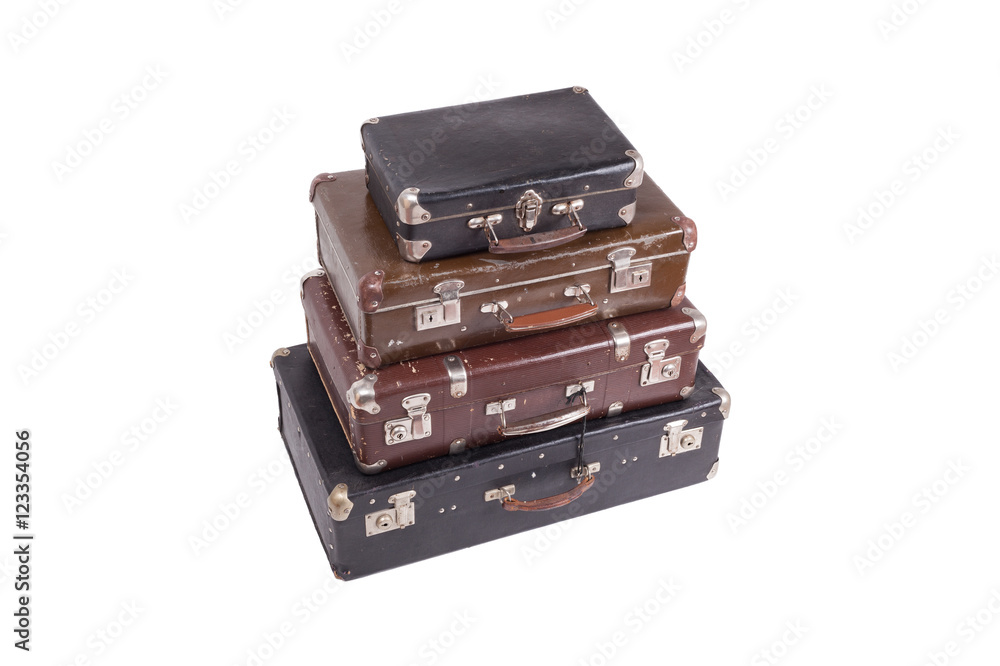 Fototapeta premium Stack of old vintage suitcases isolated on white