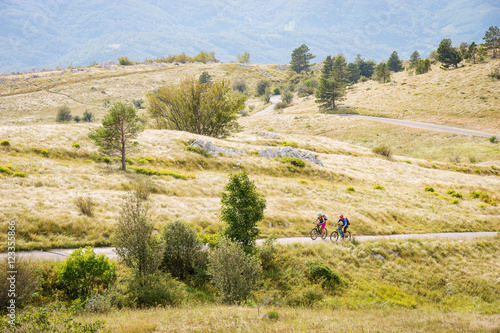 Two mountain bike riders on a road near Vipava, Slovenia photo