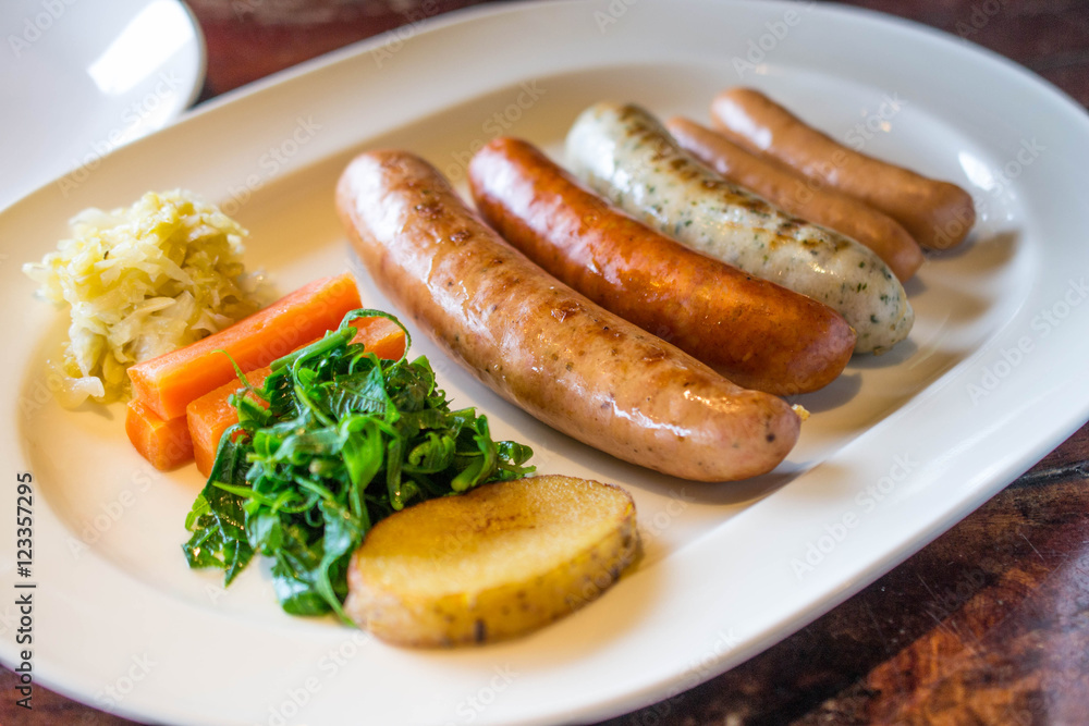 Sausage grill with vegetable on white dish Sausage grill with vegetable on white dish