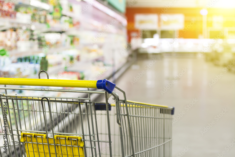 Cart at the grocery store. Abstract blurred photo of store with trolley in department store bokeh background. New ideas in trade and business.Advertising of food products. Shopping at the hypermarket. Cart at the grocery store. Abstract blurred photo of store with trolley in department store bokeh background. New ideas in trade and business.Advertising of food products. Shopping at the hypermarket.