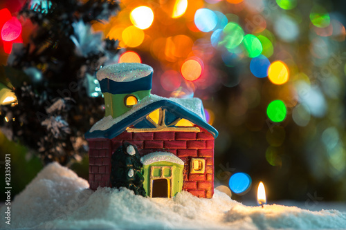 Winter background. Christmas background. Christmas snowman and candles. Close-up. Night Photography.