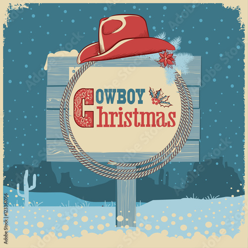 Cowboy christmas card with western hat and text on wood board