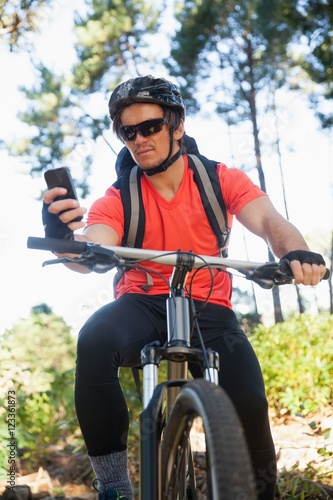 Mountain biker using mobile phone © WavebreakMediaMicro