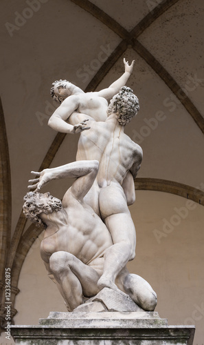 The Rape of the Sabine Women by Giambologna, in the Loggia dei Lanzi in Florence, Italy. Famous sculpture displayed in the Old Town.