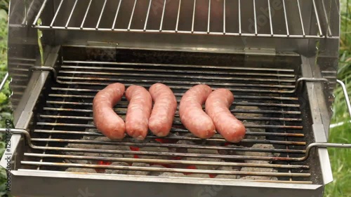 Grilled sausages on a grill photo