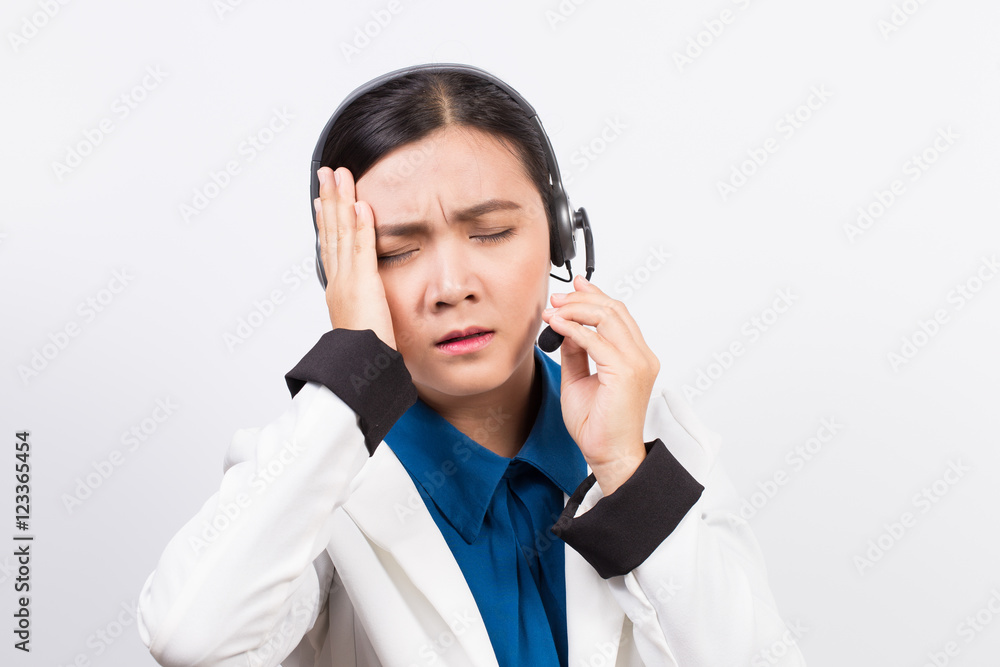 Operator or businesswoman in headset and she has headache Operator or businesswoman in headset and she has headache