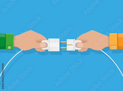 Two hands trying to connect electric plug together