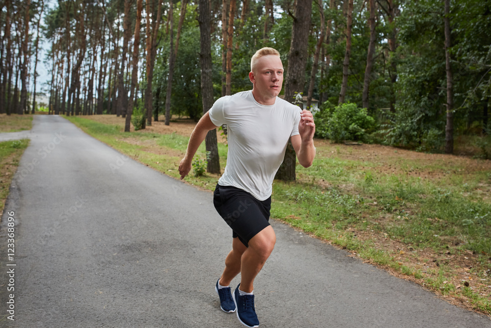 young athlete running in the forest young athlete running in the forest