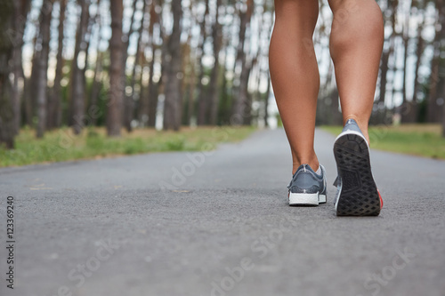 Young woman running outdoors in a city park