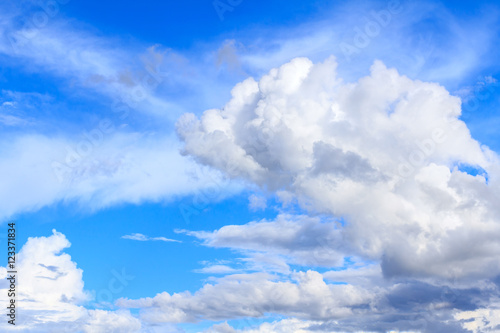 Blue sky background with white clouds and rain clouds. The vast blue sky and clouds sky on sunny day. White fluffy clouds in the blue sky.