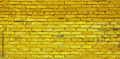 Yellow brick wall background, brick texture
