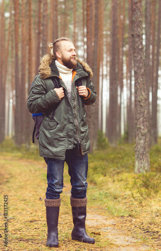 Portrait of a young traveler man in the woods © Acronym