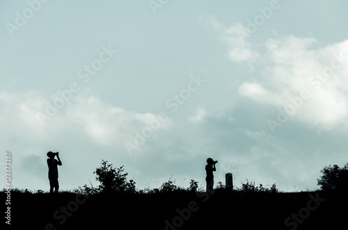 Fototapeta Naklejka Na Ścianę i Meble -  Silhouette of a standing photographer in a landscape