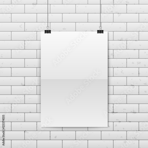 Sheet of folded paper hangs on the clamps.