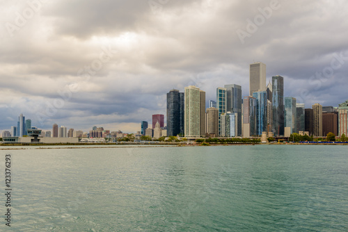 Chicago skyline with skyscrapers viewed over lake.