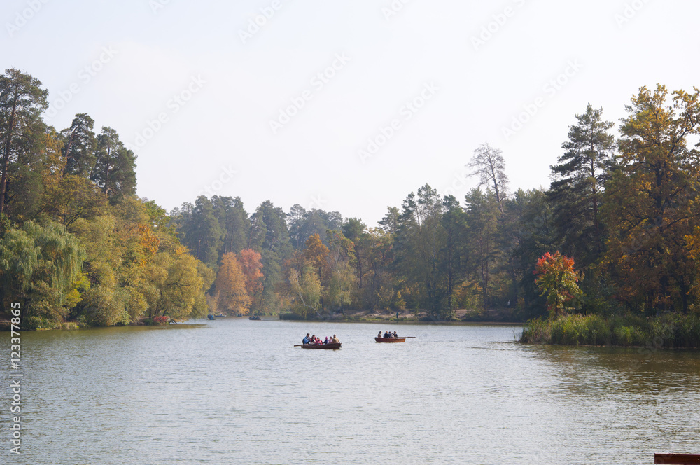 boat on lake near autumn forest