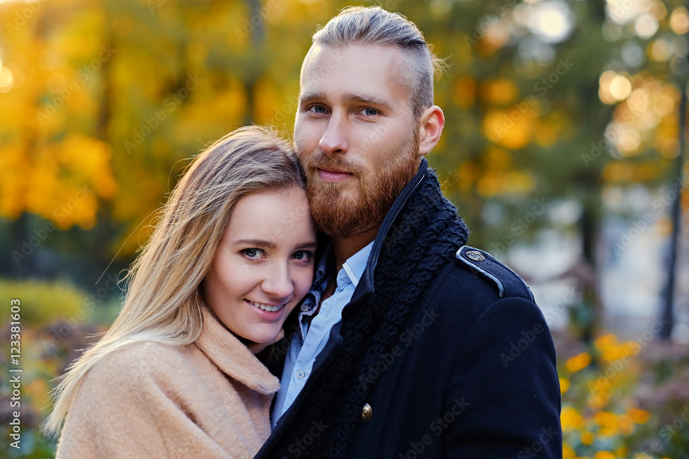 Redhead bearded male hugs the cute blonde female. Redhead bearded male hugs the cute blonde female.