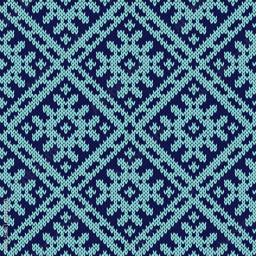 Knitting ornate seamless pattern in dark and light blue hues