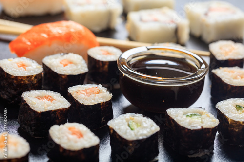Sushi rolls on a black surface