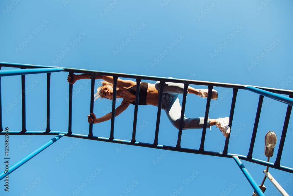 Sporty fit girl working out at outdoor gym Sporty fit girl working out at outdoor gym