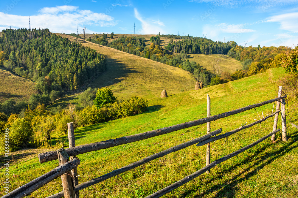 wooden fence in the grass on the hillside