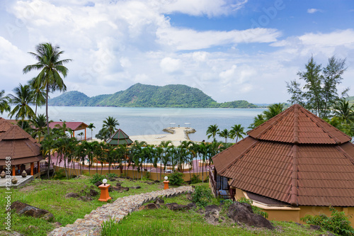 Bungalows in a tropical garden on the beach