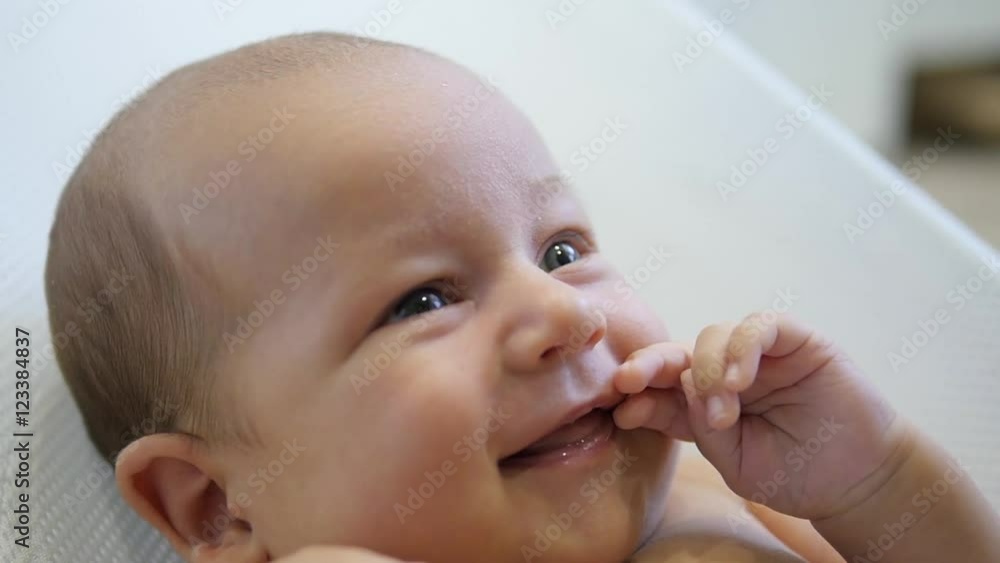 Close up portrait of amazed happy baby smiling and moving hand. Handheld shot Close up portrait of amazed happy baby smiling and moving hand. Handheld shot