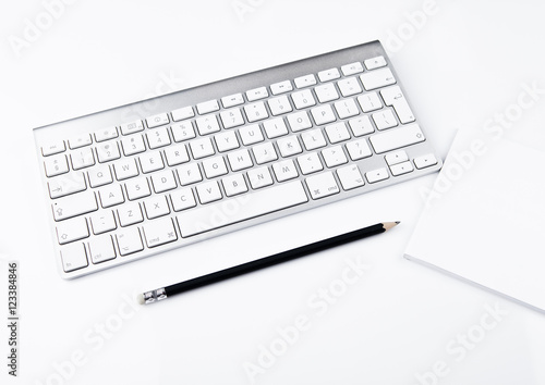 White office computer keyboard with black pencil photo