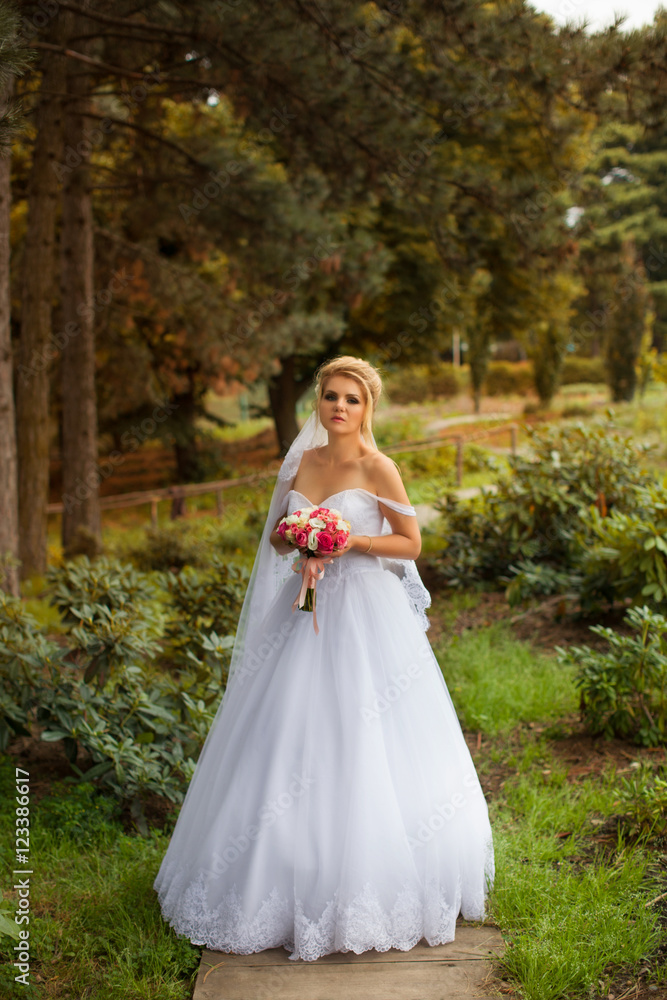 Stylish bride in a white dress on the wedding day