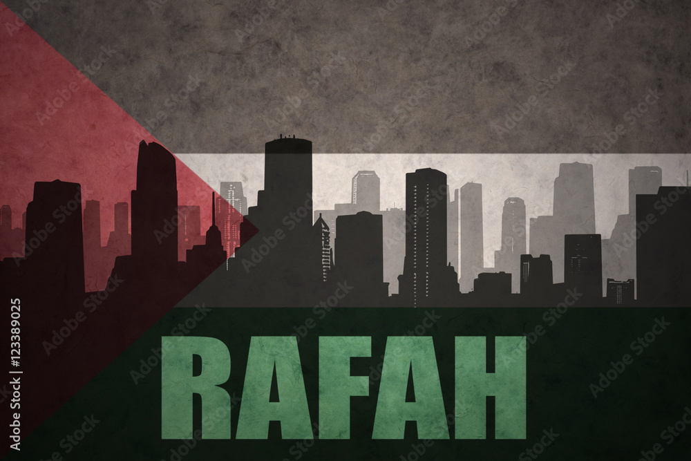 abstract silhouette of the city with text Rafah at the vintage palestinian flag background
