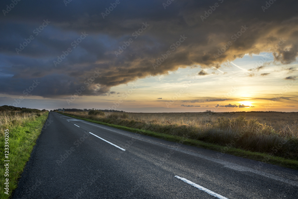 Naklejka premium Road to Kennack with stormy looking sunset, Lizard peninsula, Cornwall, UK