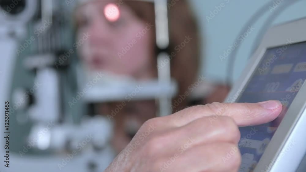 Modern medical procedure. Ophthalmologist points at touchscreen during eye examining. HD. Modern medical procedure. Ophthalmologist points at touchscreen during eye examining. HD.