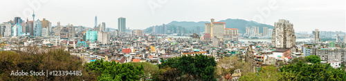 Panoramic cityscape view of Macau from the top platform of Mount Fortress displaying harmonic blend of skyscrapers and low-rise housing estate of the historic city center
