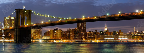 Panoramic image of the Brooklyn Bridge illuminated at night © kmiragaya