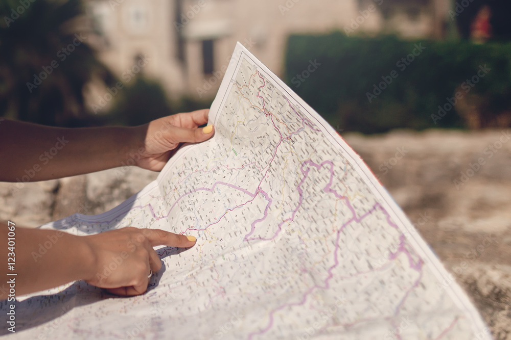 Naklejka premium Woman traveler with map in old town at daytime
