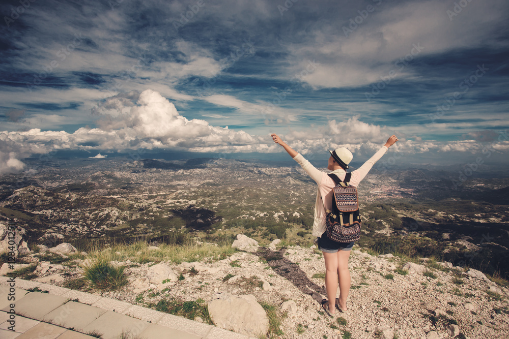 Woman traveler on high mountain, hands up Woman traveler on high mountain, hands up