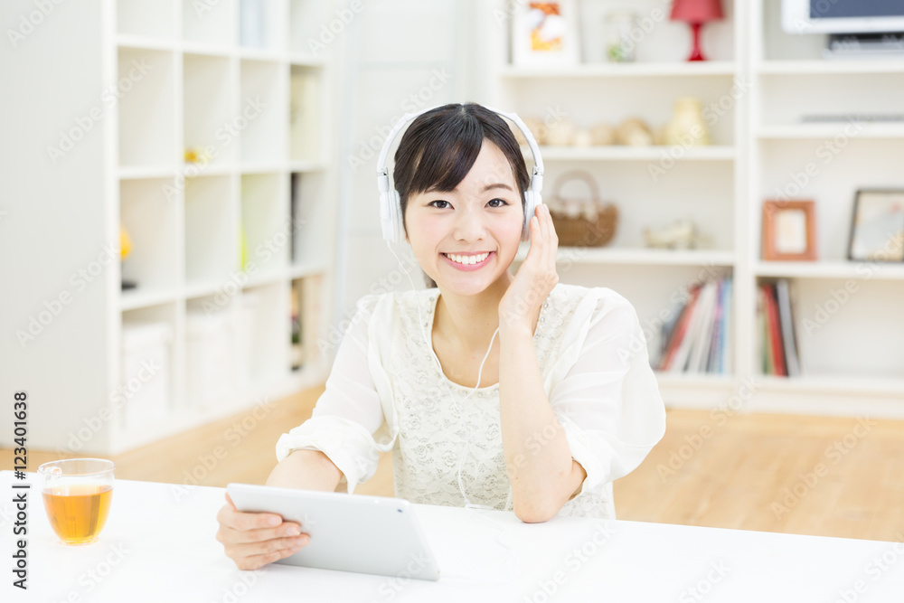 attractive asian woman using tablet computer attractive asian woman using tablet computer