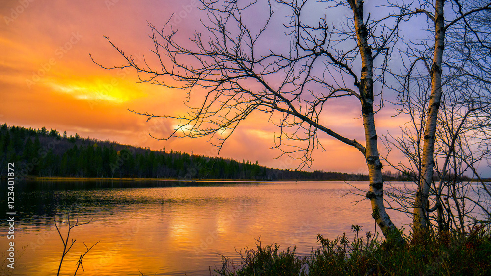 Autumn landscape.Bright autumn sunset over forest lake Autumn landscape.Bright autumn sunset over forest lake