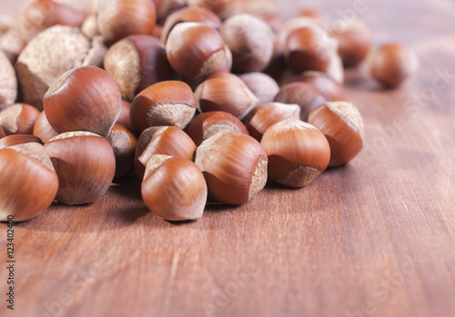 Hazelnuts on wooden background. Focus on the foreground