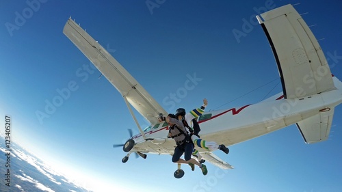 Sky diving tandem friends jump from the plane